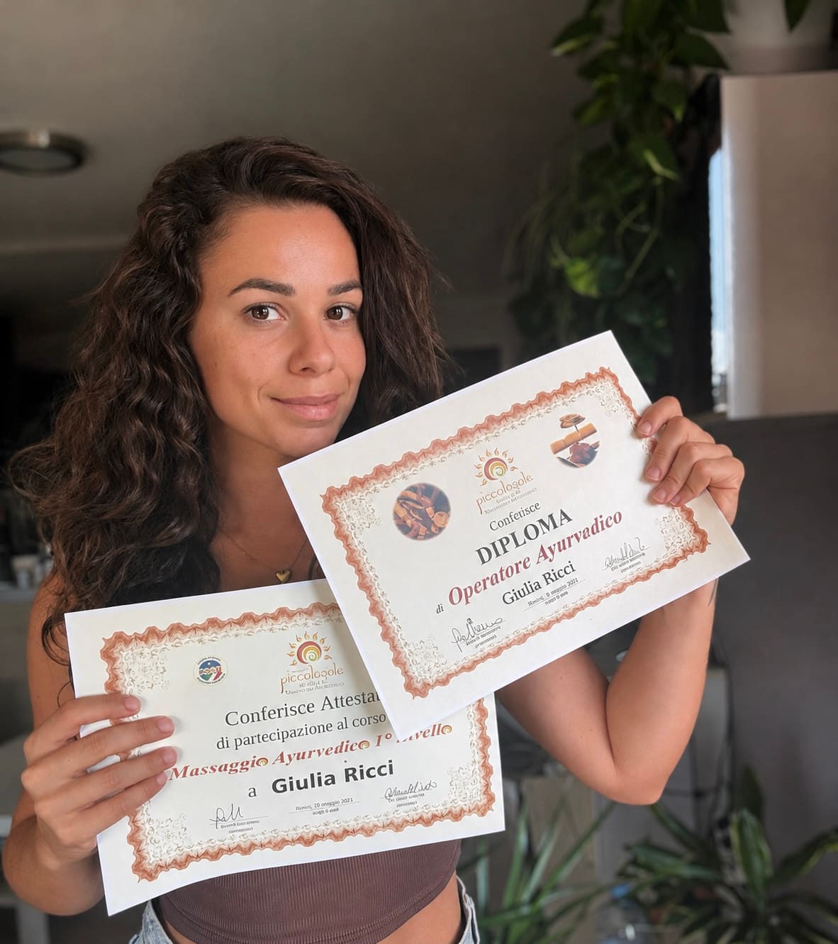 Giulia con sus diplomas de terapias ayurvédicas